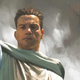Jedi Master Elzar Mann raises his lightsaber to the air in a misty outcrop on the cover of The Rising Storm.